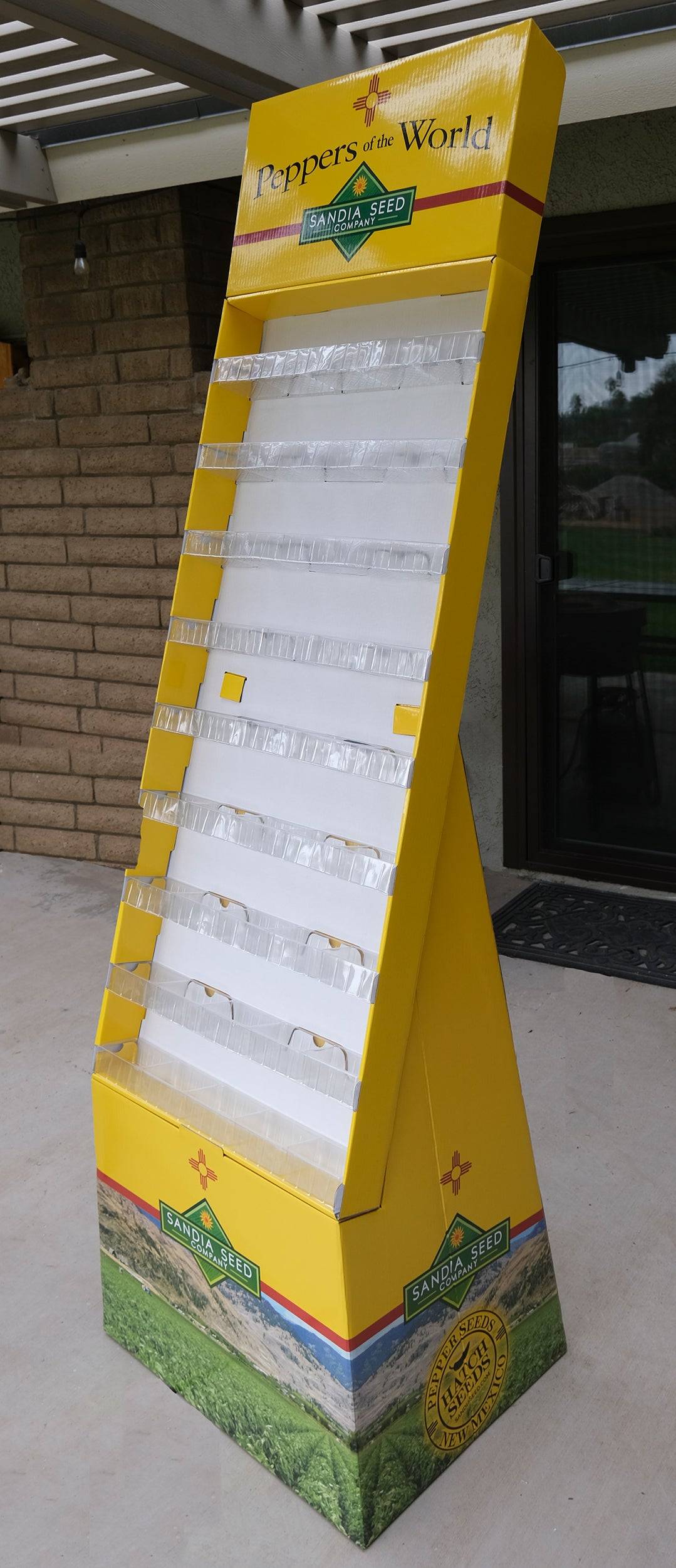 Seed Display - Floor Display with 45 pockets, Empty; tall yellow cardboard rack with clear pockets and branded header, ideal for garden seed sales.