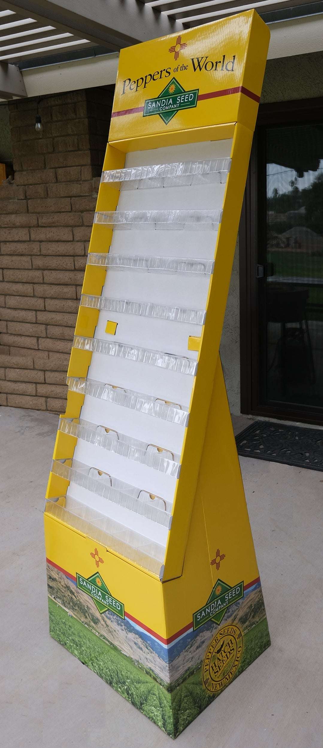 Seed Display - Floor Display with 45 pockets, Empty; tall yellow cardboard rack with clear pockets and branded header, ideal for garden seed sales.