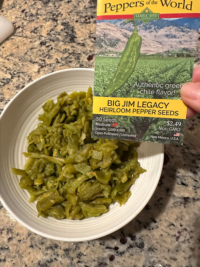 Roasted Big Jim Legacy green chile in a bowl with seed packet, perfect for chile rellenos and traditional New Mexican dishes.