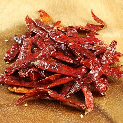 Dried Santaka Japones peppers with deep red color, ideal for adding intense heat to Asian dishes and spice blends.