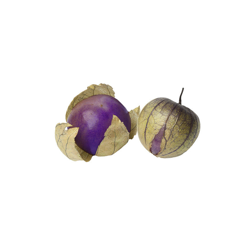 Purple tomatillos with papery husks partially peeled, showcasing the sweet and juicy variety from Purple Tomatillo Seeds - ideal for home gardens.