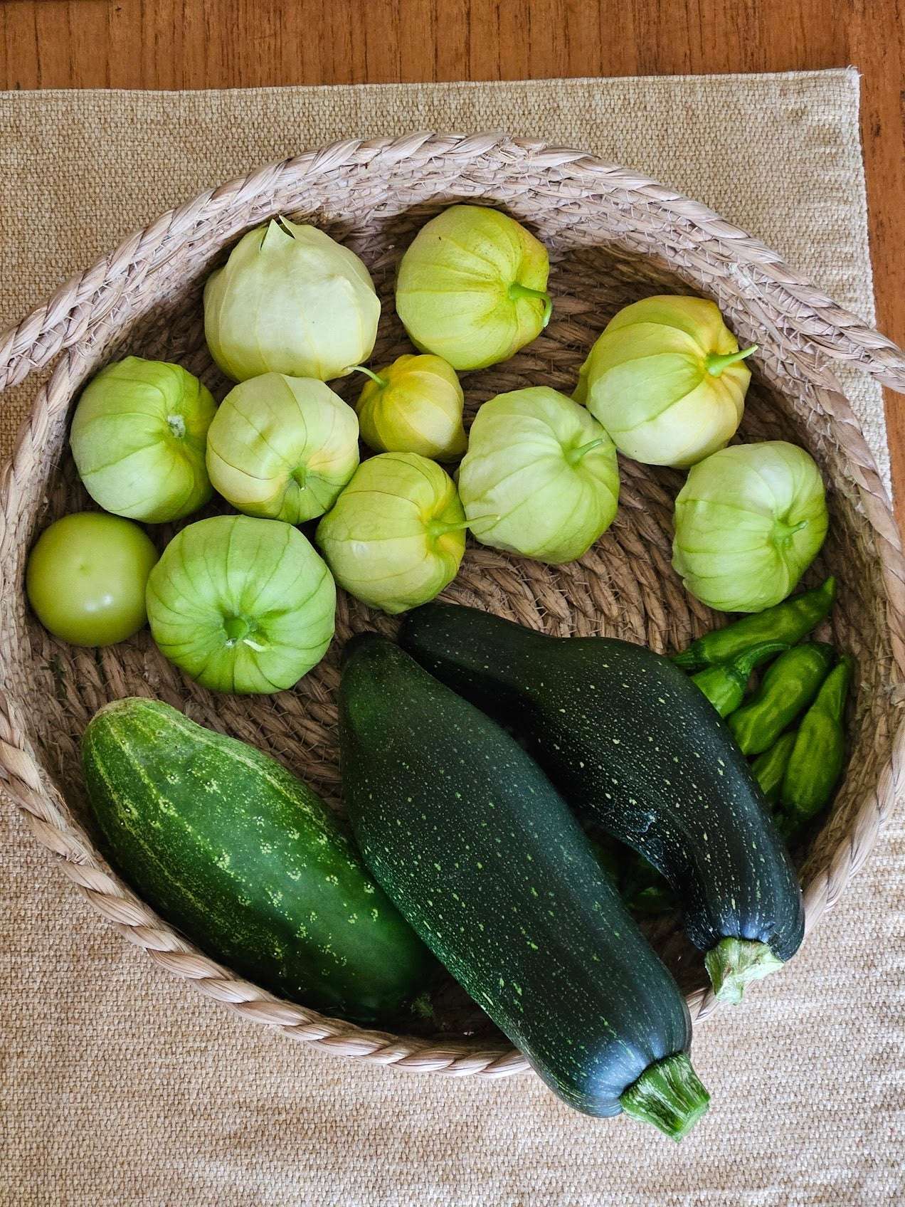 Harvest basket with Black Beauty Zucchini, tomatillos, and cucumber, highlighting fresh summer produce grown from easy-to-grow seeds.