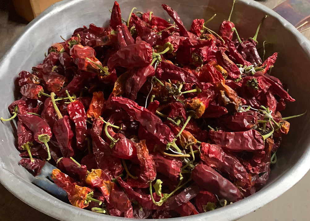 Large bowl filled with dried Chimayo chile peppers, prized for their heirloom flavor and medium heat, perfect for red chile sauce.