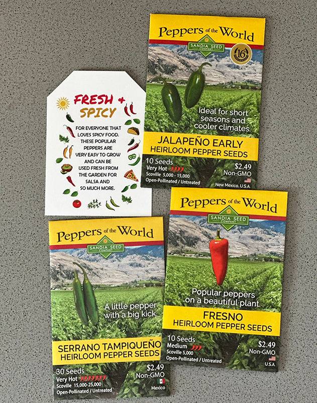 Flat lay of Pepper Seeds 3-Pack - Spicy Garden with Jalapeño, Fresno, and Serrano seed packets and a Fresh & Spicy info card.
