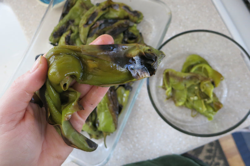 How to Roast Hatch Chiles - roasted chiles in hand, ready to be peeled


