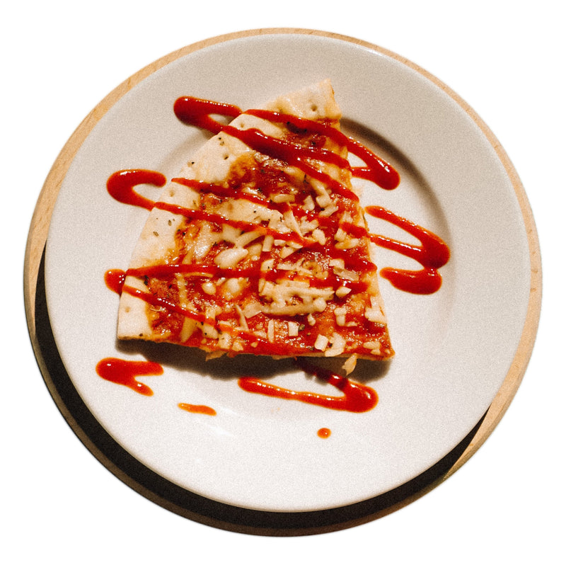 Homegrown Sriracha Sauce Recipe - shown drizzled over pizza

